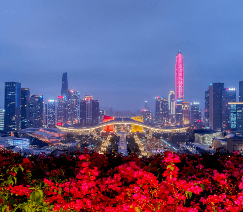 Night view of Shenzhen city center with illuminated skyscrapers and busy streets